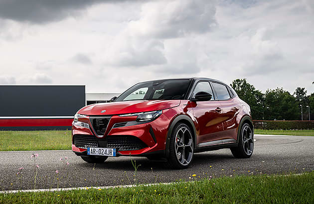 A red Alfa Romeo EV on a tarmac