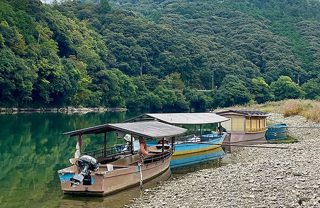 Old wooden boats on the shore of river in Ozu, Japan
