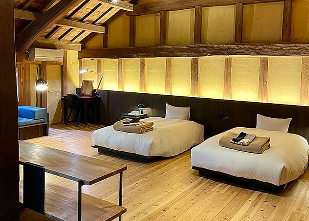 A bedroom, with a timber roof and floor in Ozu, Japan