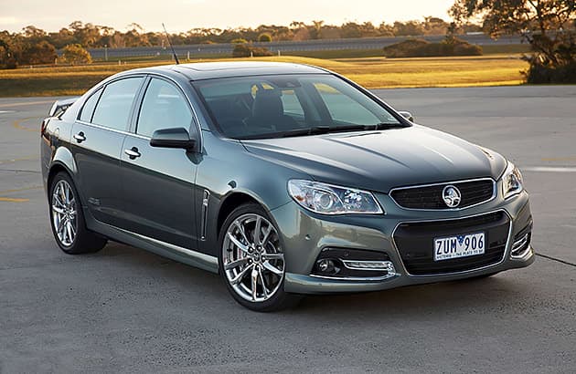 A grey Holden Commodore VF parked on a tarmac.