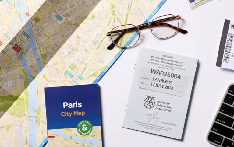 An IDP document and a large map on a table with some spectacles
