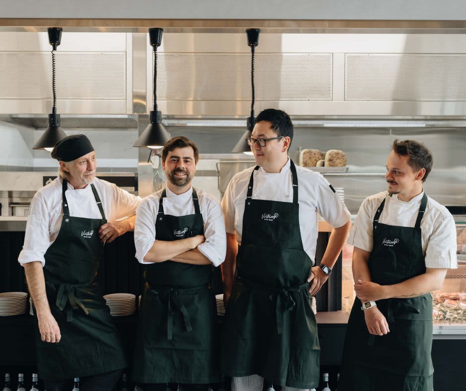 Four chefs at Vintners Bar stand together in aprons smiling