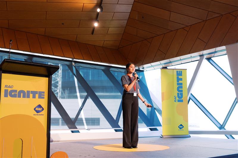 Woman standing on stage with microphone