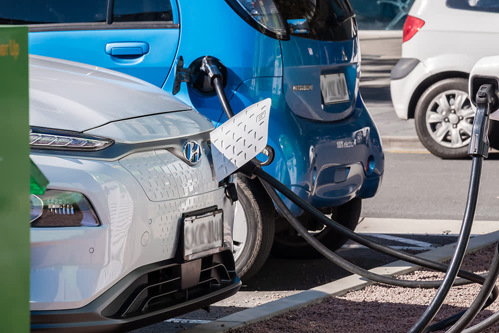Two cars charging at a public charger in a carpark