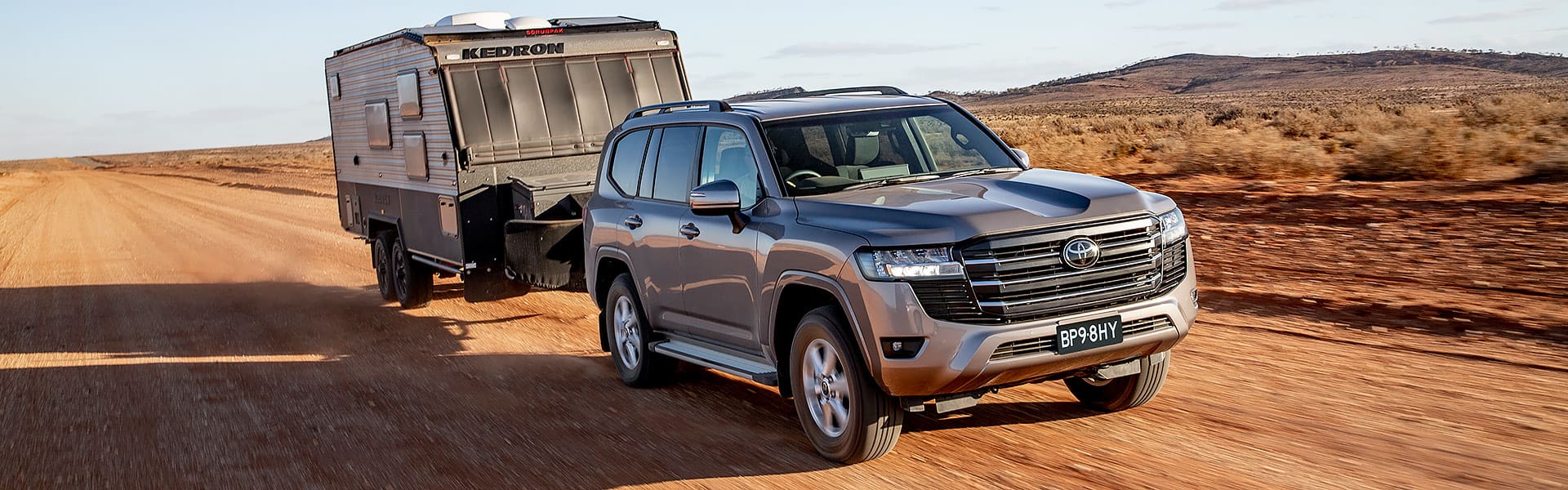 A Toyota Landcruiser 300 series towing a caravan
