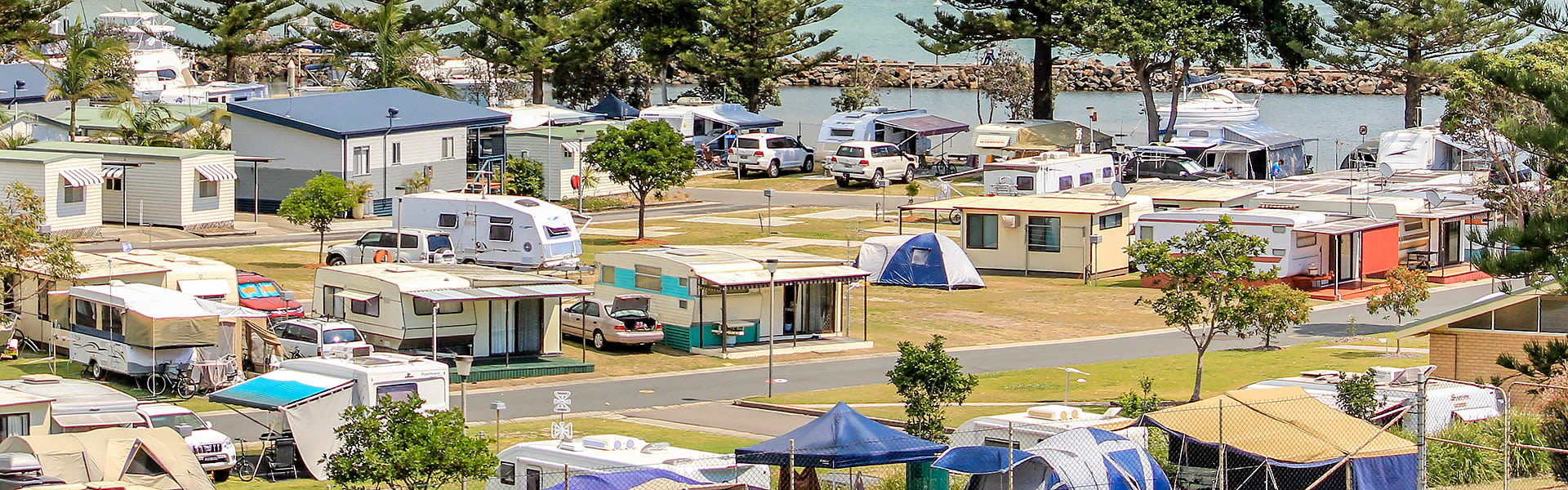Caravans and tents near water