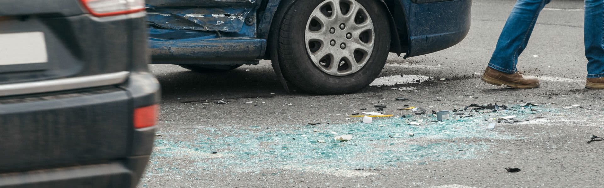 A car crash with broken glass on the floor