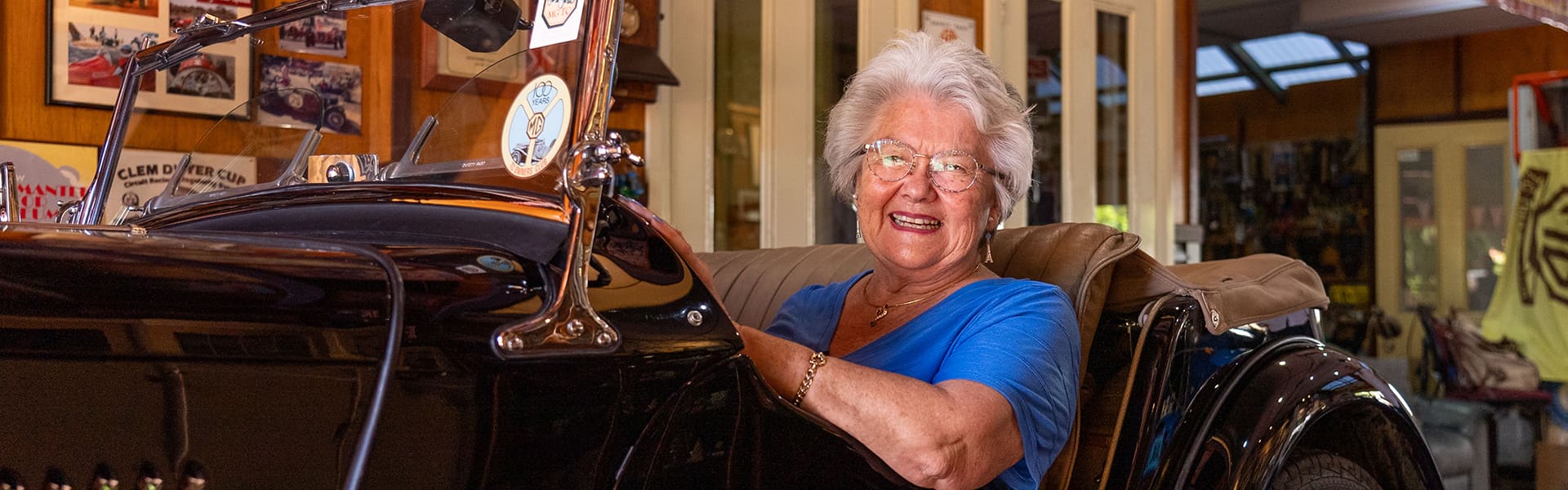 Mary Ann posing with her 1947 MG TC inside her garage