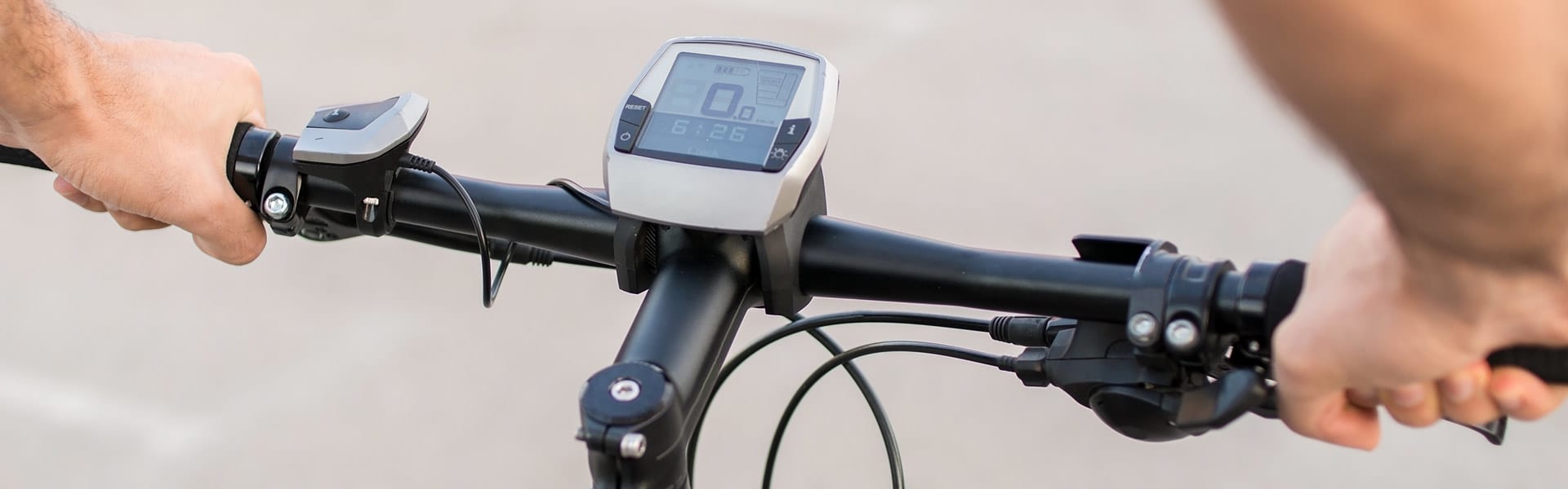 The handle bars and digital display on an e-bike