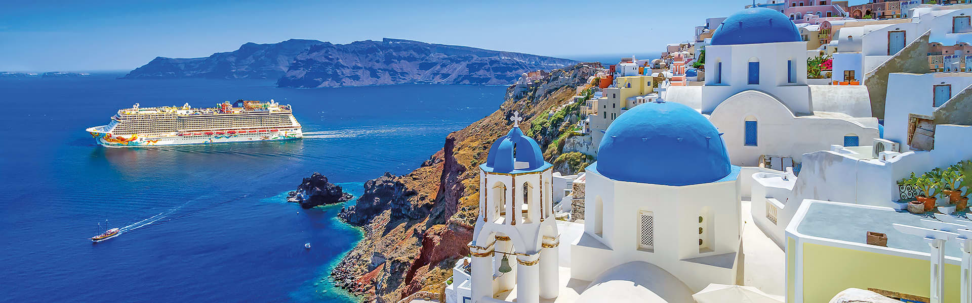 A ship cruising the Mediterranean with a mountainous landscape in the distance
