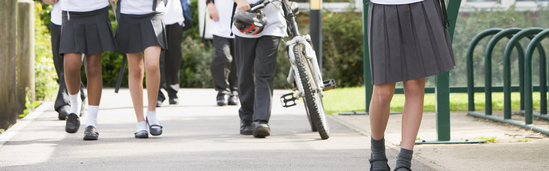 School students standing near the bike rack on campus