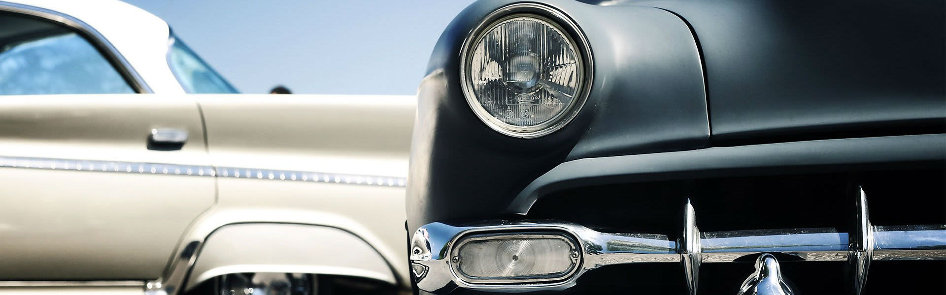 A front view of an old black vintage car