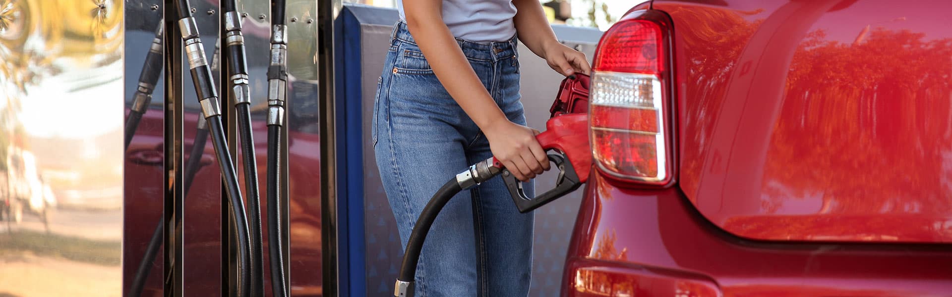 Woman putting fuel in her car