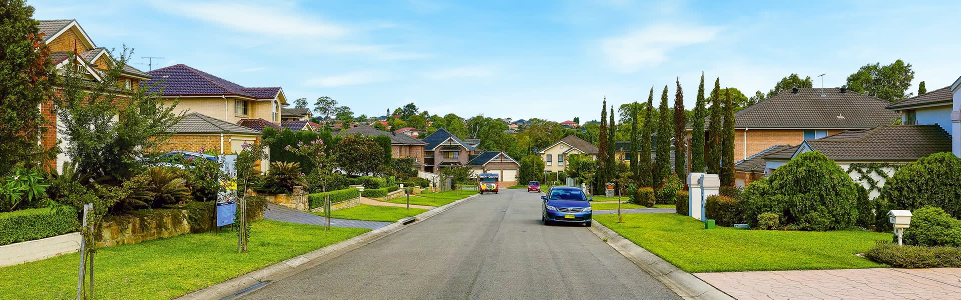 Suburban street with houses and cars