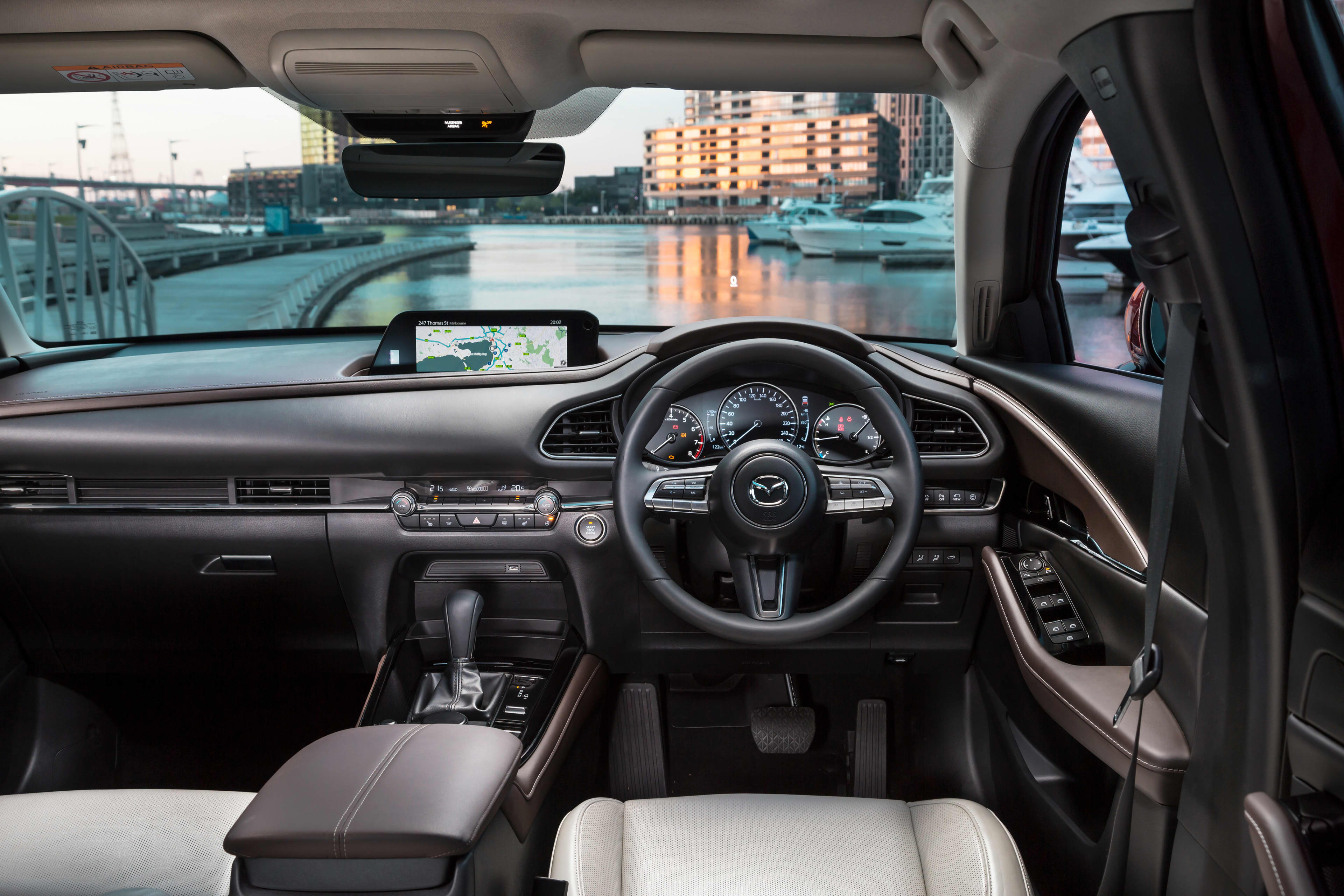 Mazda CX30 interior including centre console, front dashboard and steering wheel