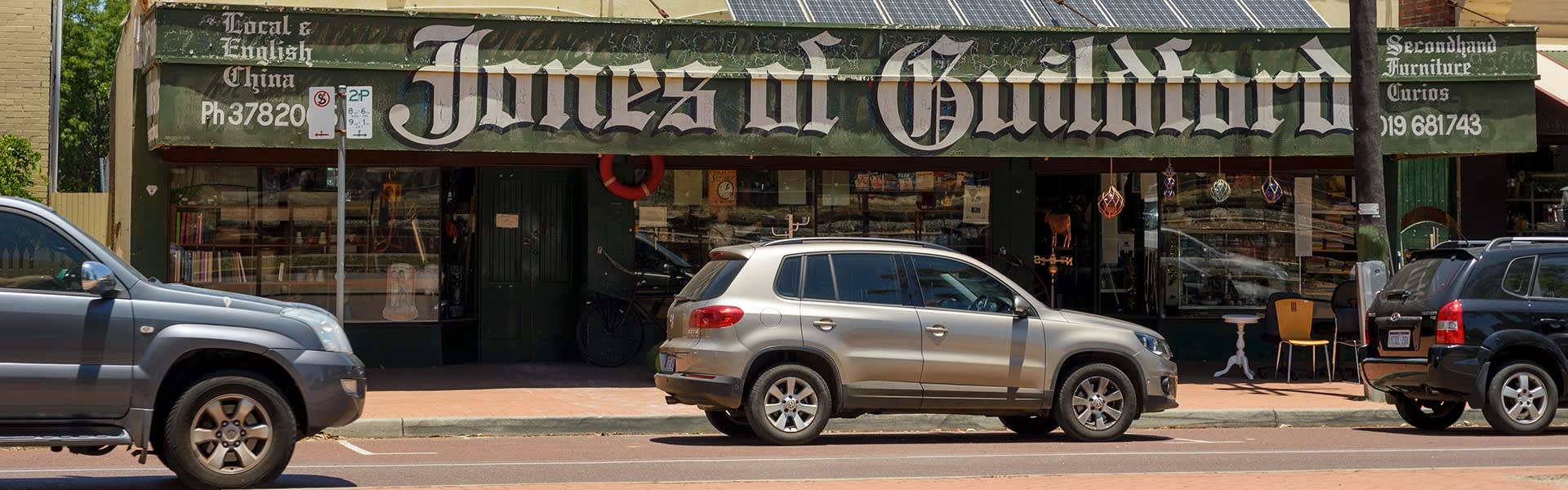 Cars parked in front of Jones of Guildford shop.