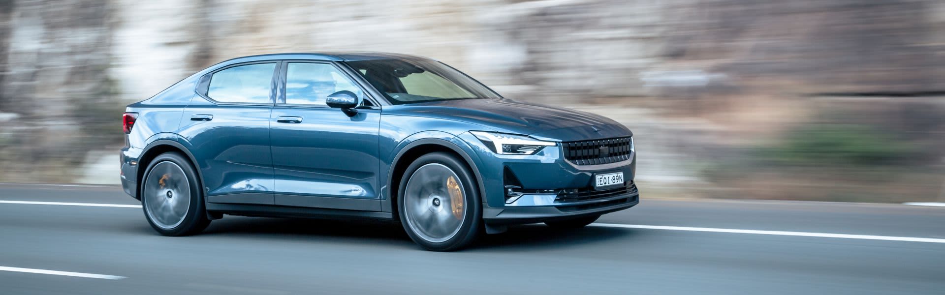 Blue Polestar driving on road