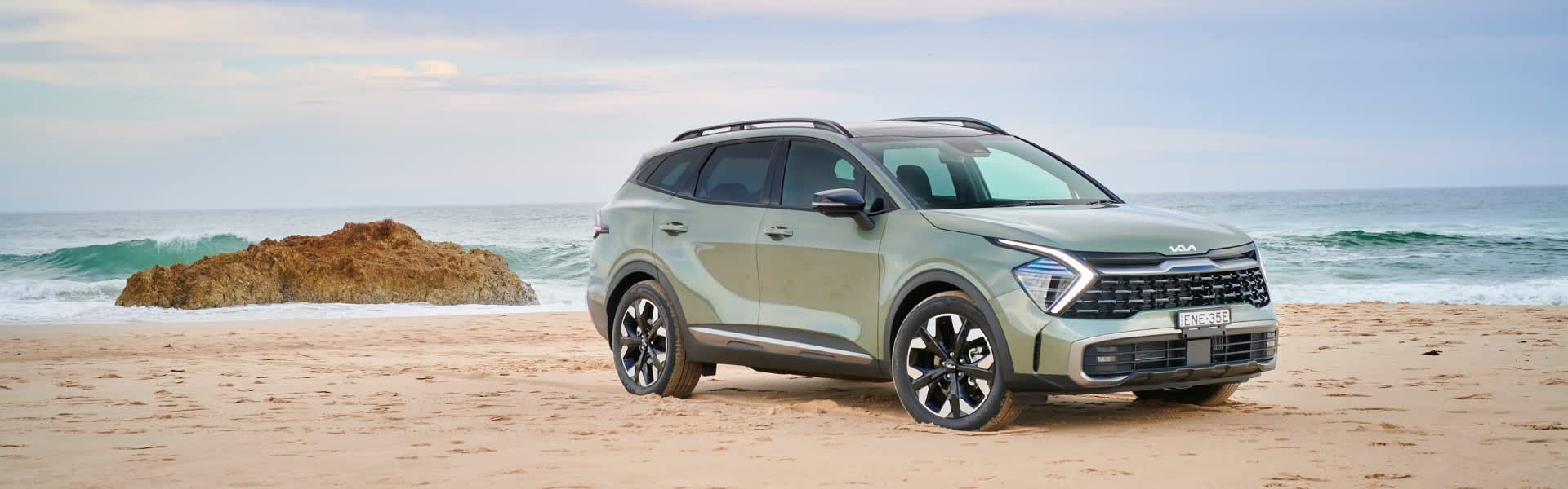 Grey Kia Sportage on the beach