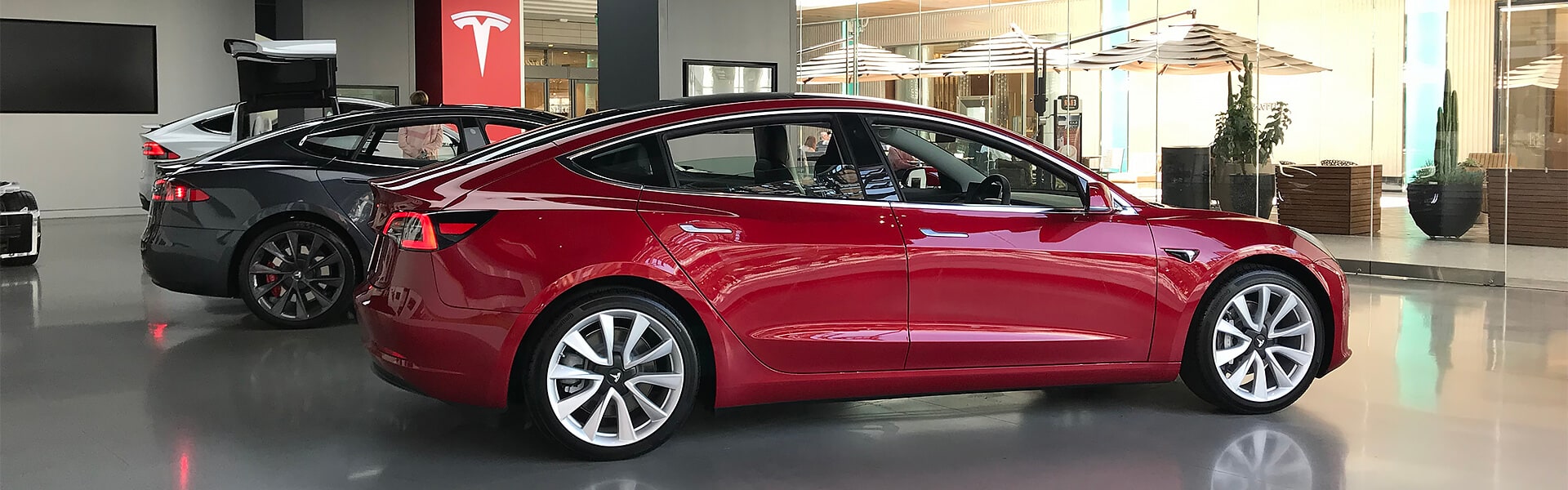 Three Tesla cars in a Tesla showroom