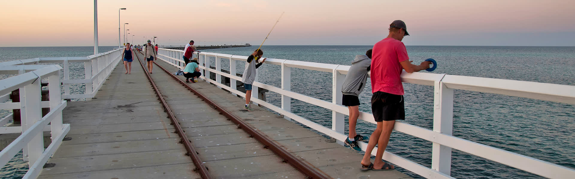 A father and son fishing from Busselton Jetty