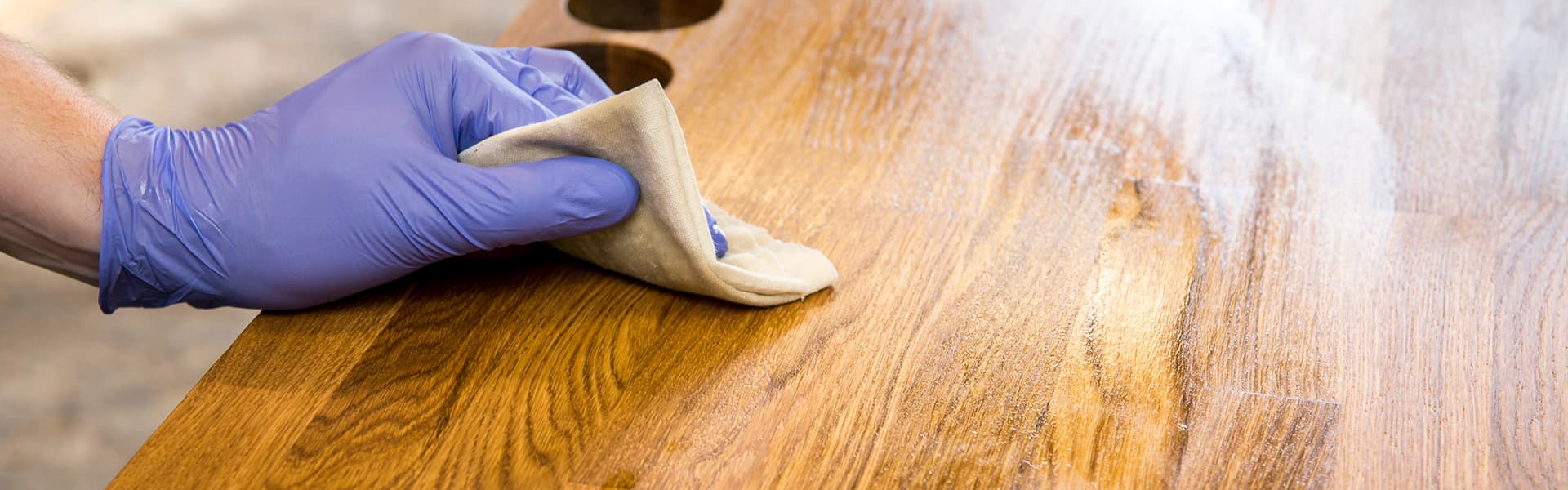 Person wiping furniture with cloth