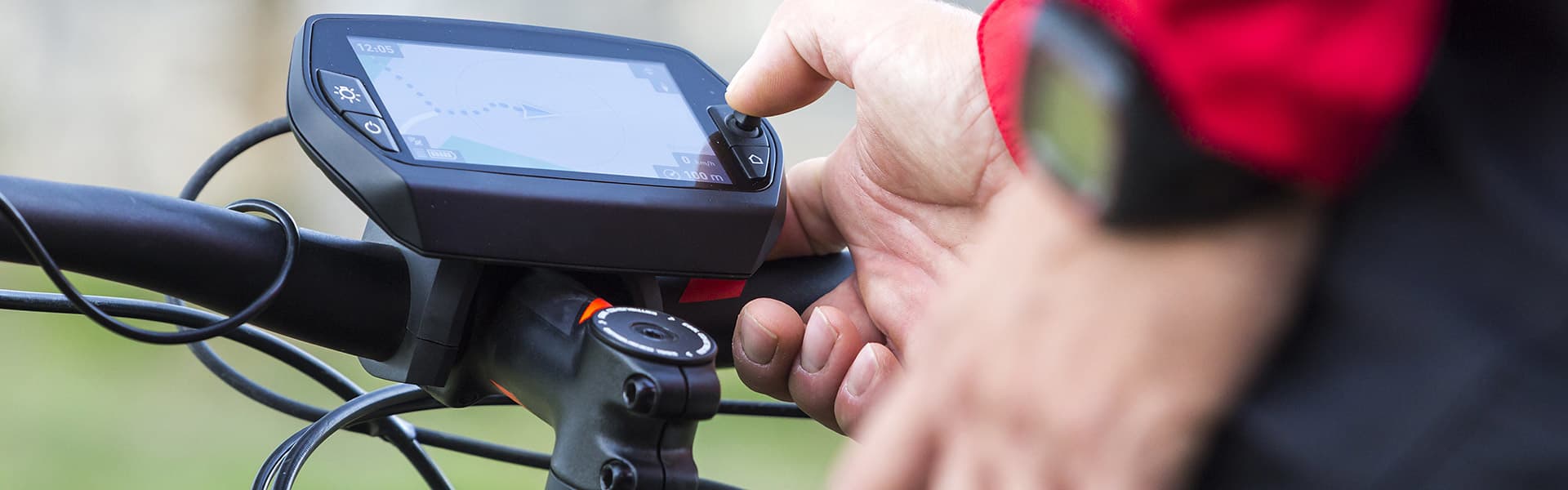 Man adjusting controls on an ebike screen