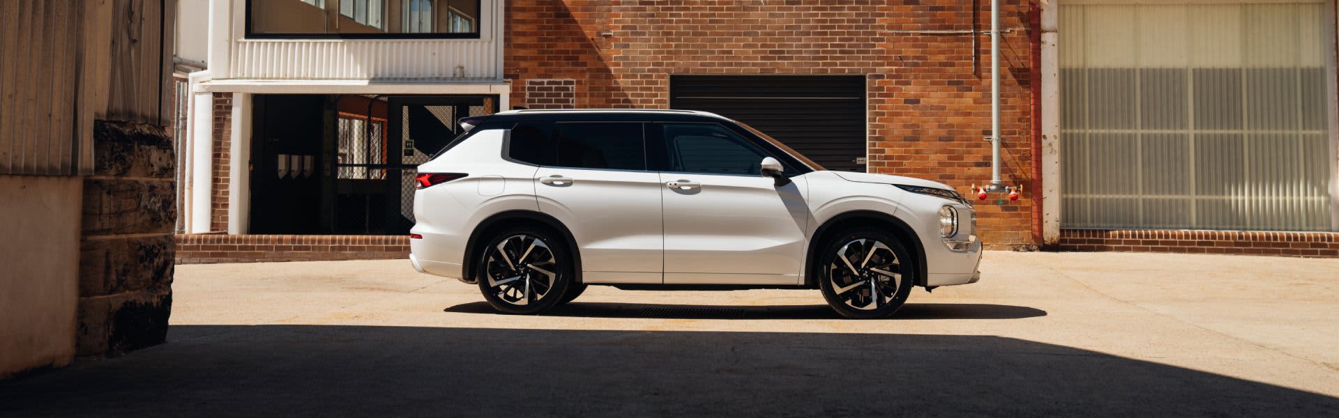 White Mitsubishi parked in urban setting