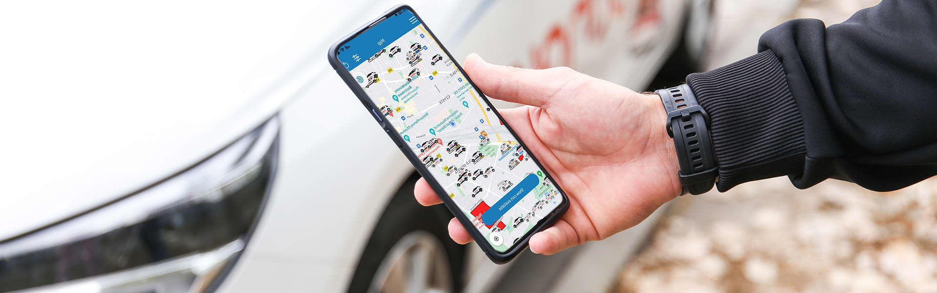 A person checking a car share app