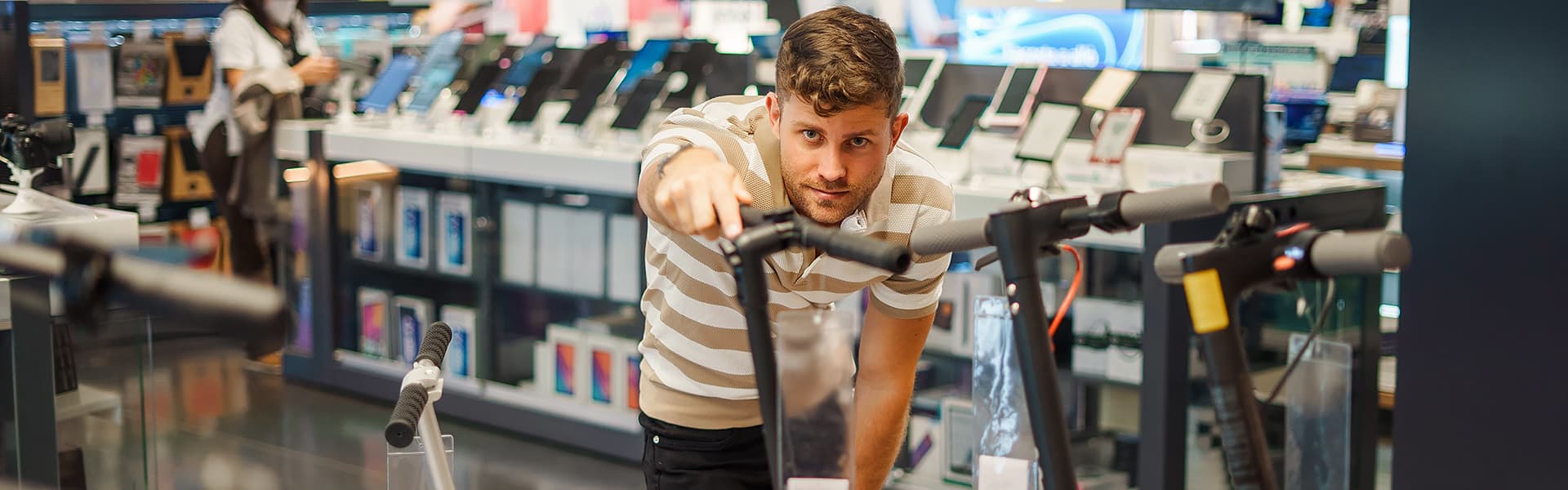 A person looking at an e-scooter in a store