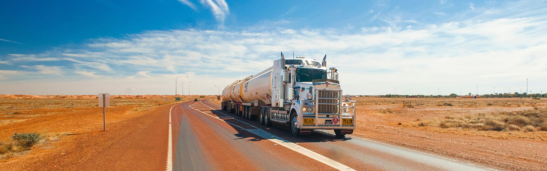 A truck driving down a highway in outback Australia