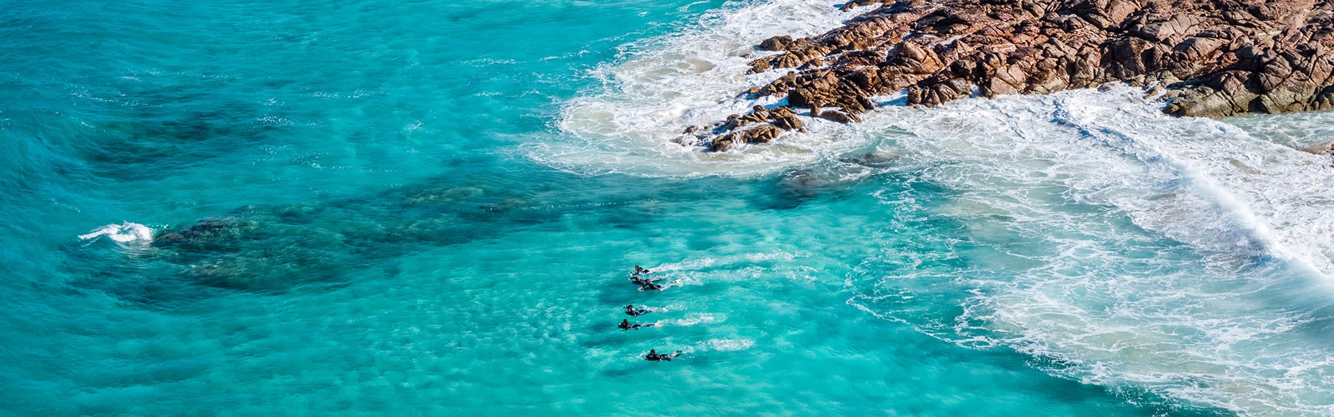 Overhead shot of surfers in the ocean at the Canal Rocks in Yallingup.