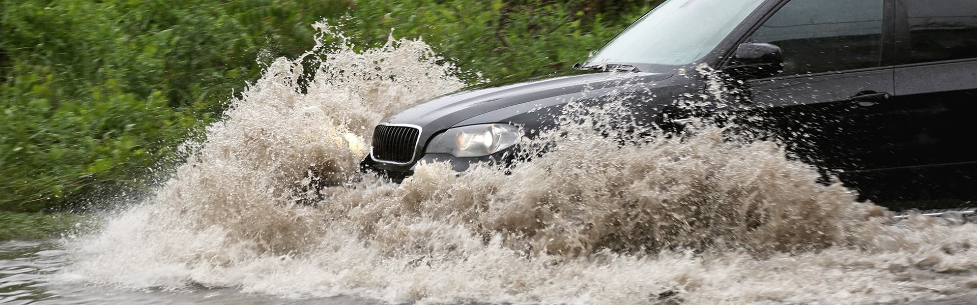 Car driving through heavy water