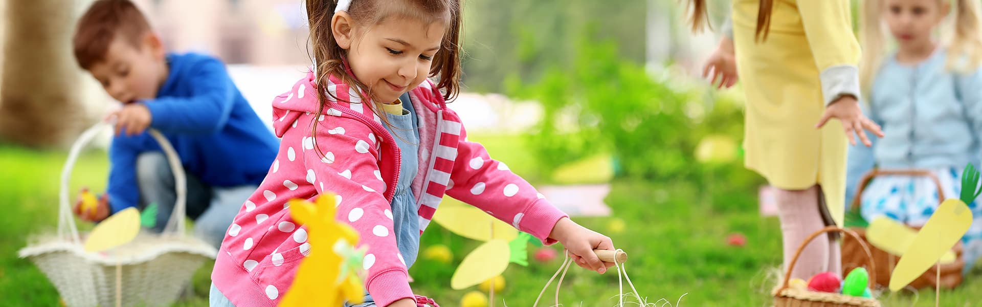 Children collecting Easter eggs in baskets