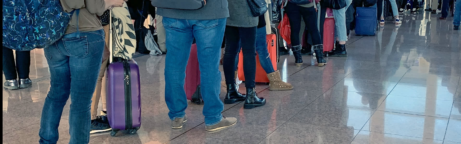 A queue of passengers in an airport