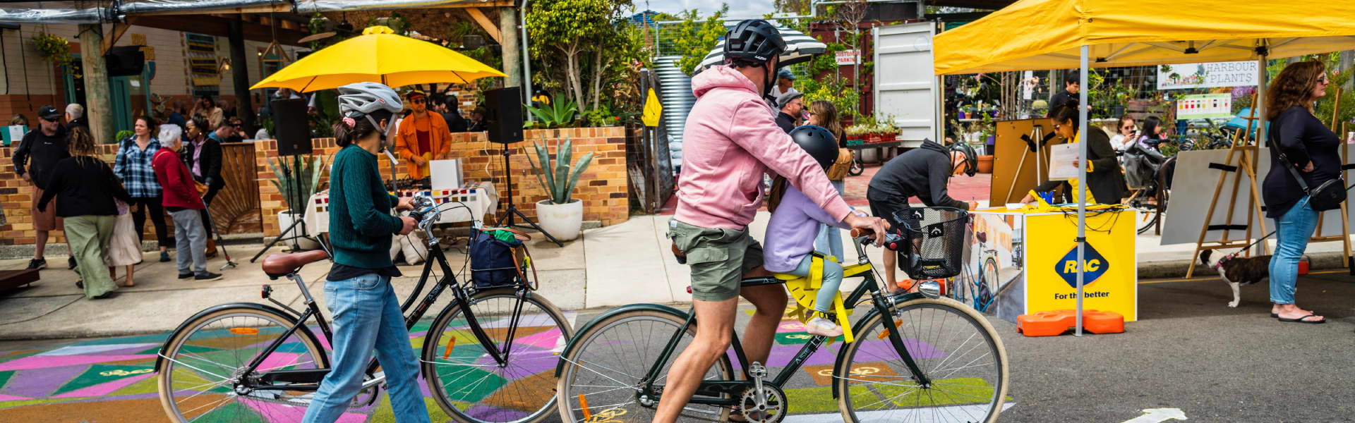 Two people walking their bikes through South Freo.