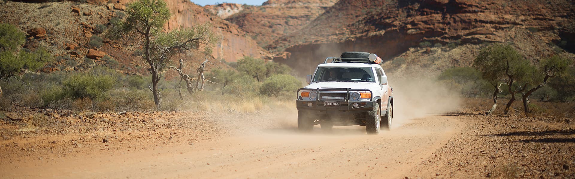 Car driving down a dirt track