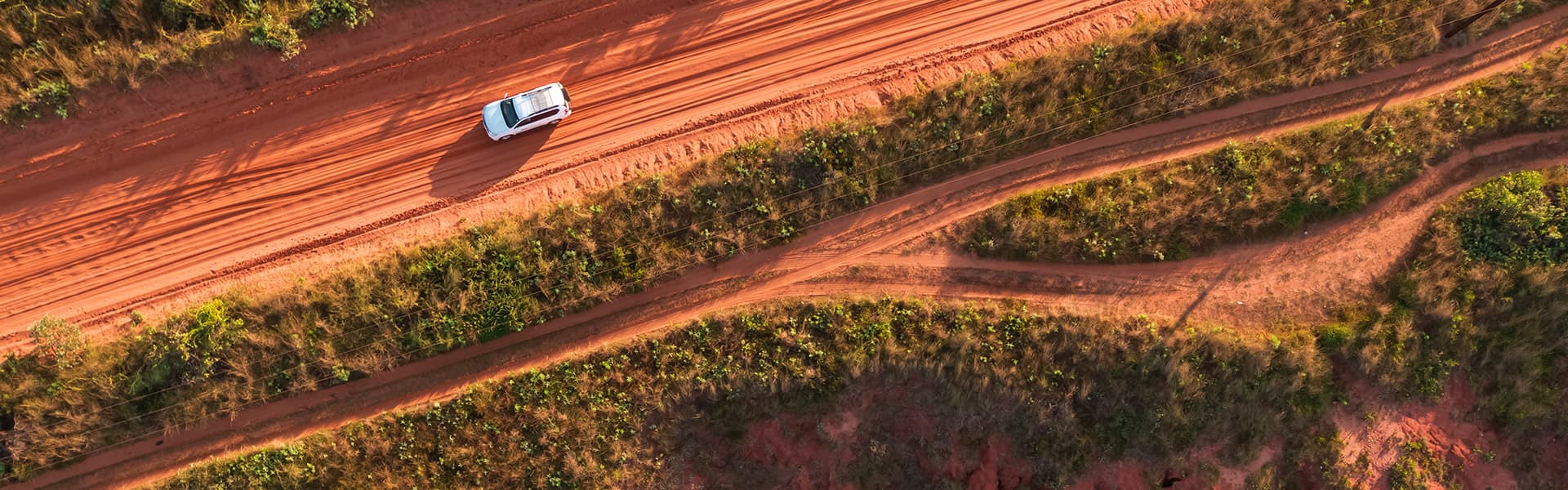 Car driving down a dirt track