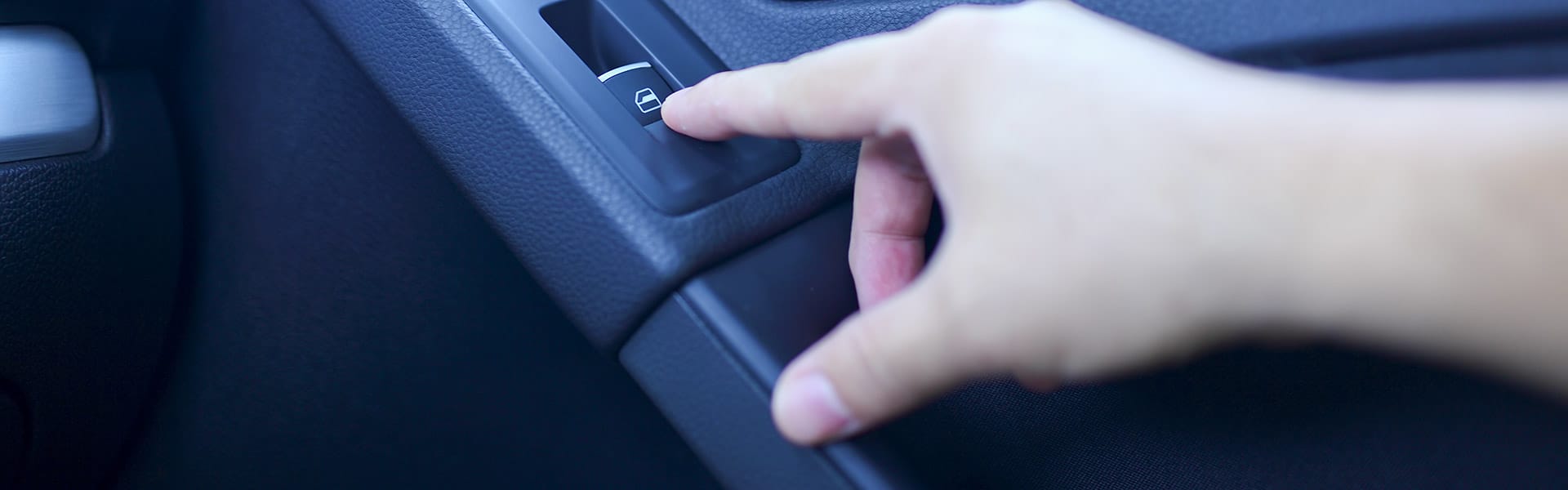 Hand on a car door lock