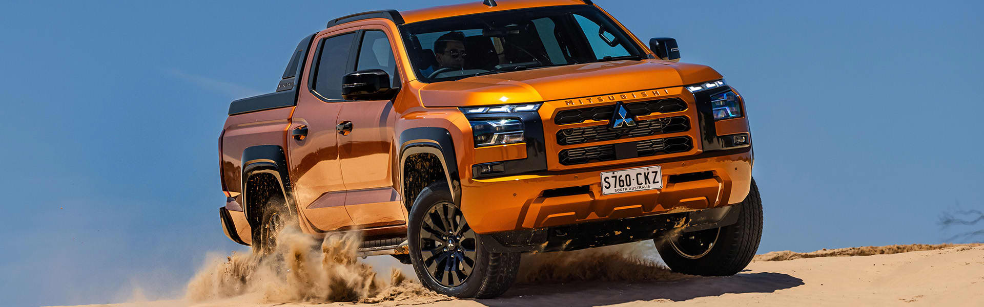 2024 Mitsubishi Triton driving in sand