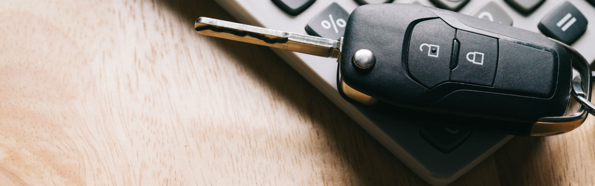 A set of car keys on a calculator