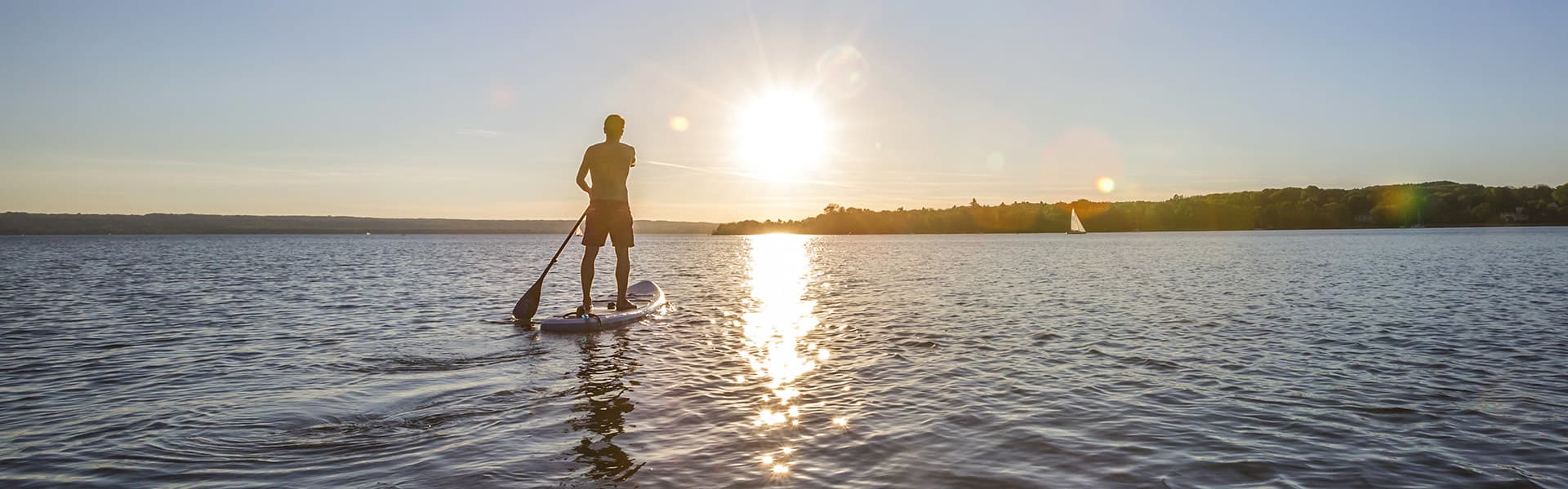 Stand up paddle boarding at sunset