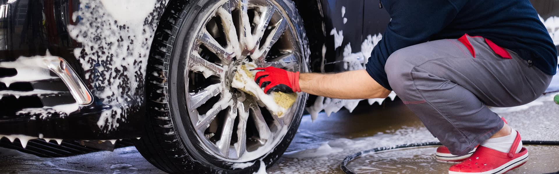Man washing car wheels