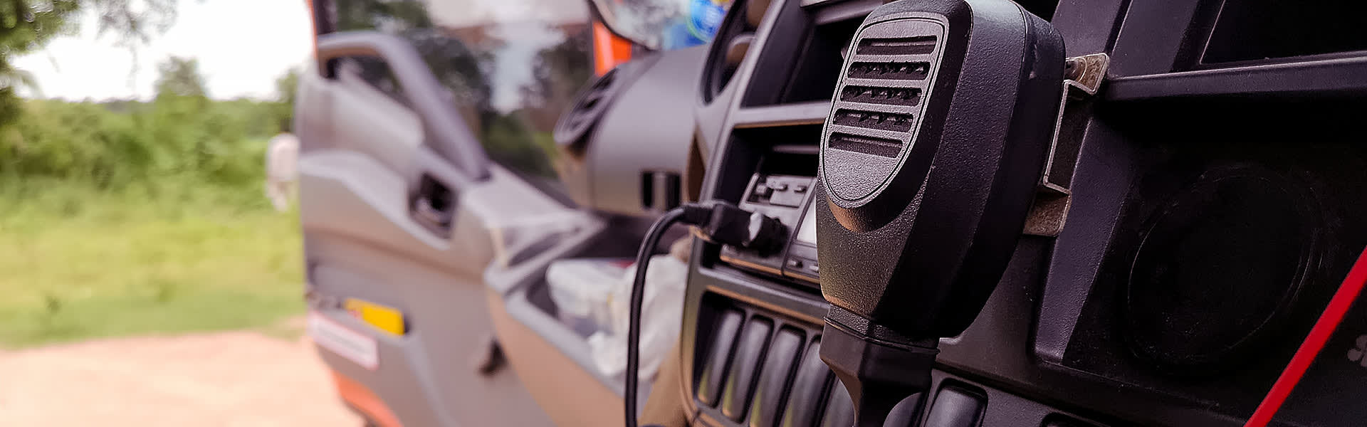 A close-up of car interior with a UHF radio in the dashboard