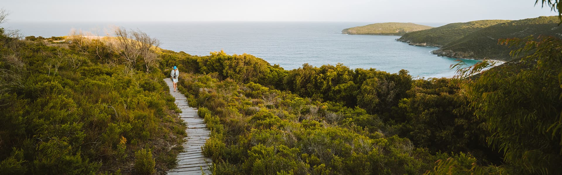 Person hiking down to the ocean