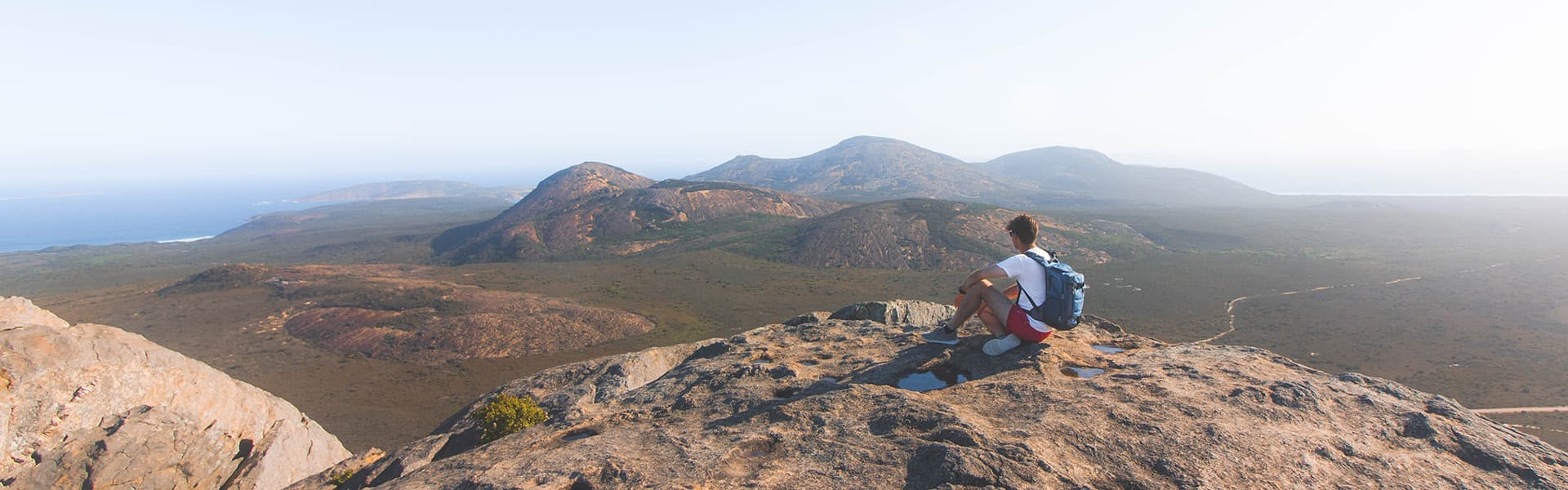 Image of hiker atop a mountain