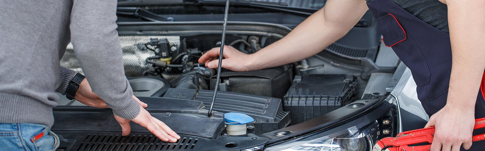 Two men working on a car engine