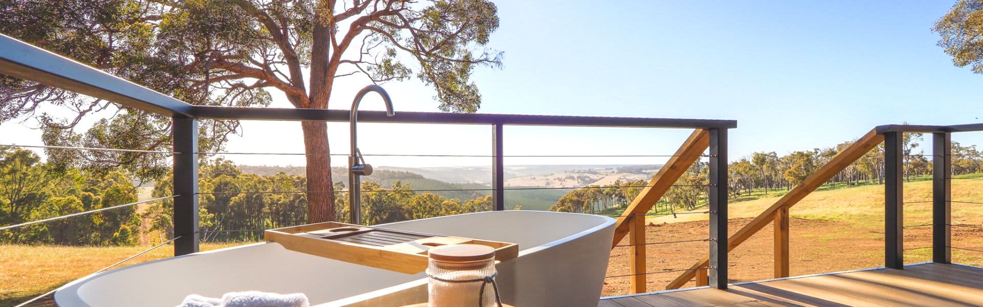 Image of spa bath on deck overlooking countryside and trees