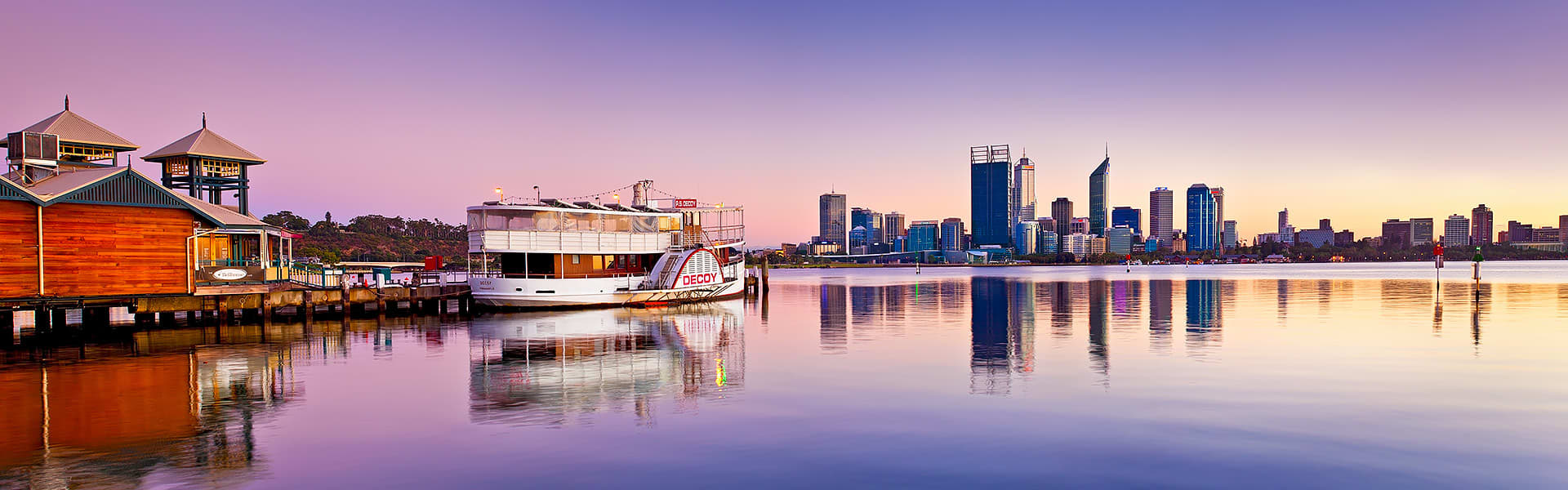Perth City skyline at sunset from South Perth foreshore with a paddle steamer to the right of frame