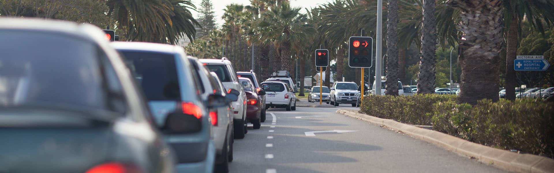 Image of cars lined up at red traffic light