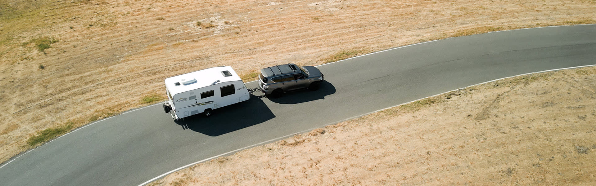A 4WD towing a caravan on a road